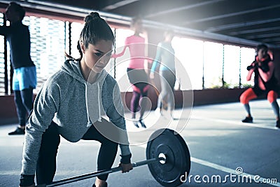 Fit healthy woman lifting a weight barbell Stock Photo