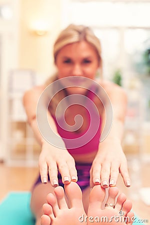 Fit healthy young woman doing stretches Stock Photo