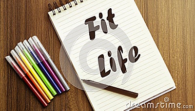 Fit Life. your future target searching, a marker, pen, three colored pencils and a notebook for writing Stock Photo