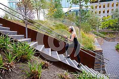 Fit sports women doing hard interval workout in stairs in city park Stock Photo