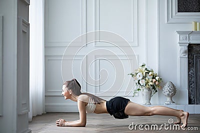 Fit sportswoman exercising and training at home Stock Photo