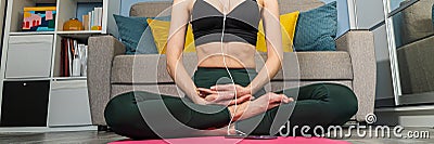 Fit woman doing yoga on mat at home in the bedroom. Young woman meditating indoors. A series of yoga poses Stock Photo