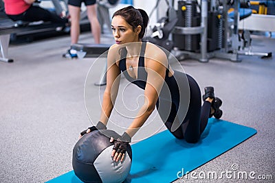Fit woman exercising with medicine ball workout out arms Exercise training triceps and biceps doing push ups Stock Photo