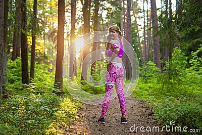 Woman during her run through woods Stock Photo