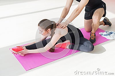 Fit woman high body flexibility stretching her leg Stock Photo