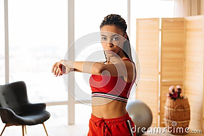 Fit woman with nice body doing tabata at home in the morning Stock Photo