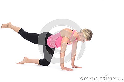 Fit woman strengthening her thigh muscles Stock Photo