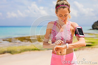 Woman using wearable tech during workout Stock Photo