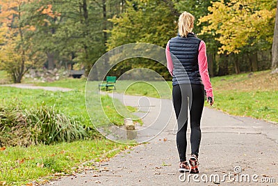 Fit woman walking in park Stock Photo