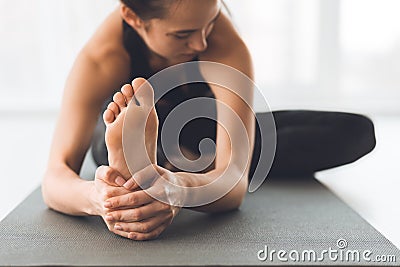 Fit woman warmup stretching, training indoors, focus on foot Stock Photo