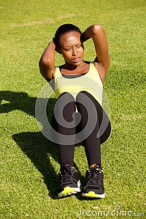 Fit young african woman doing stomach crunch Stock Photo