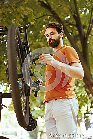 Dedicated man using bike repair-stand Stock Photo