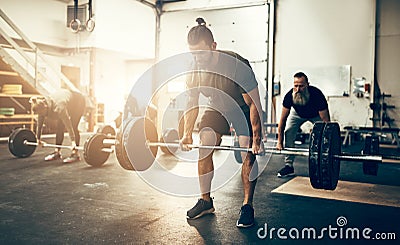 Fit young man lifting weights in a gym Stock Photo