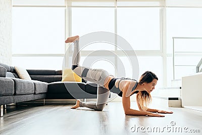 Adult Woman Training Legs and Back Doing Plank Donkey Kicks Stock Photo