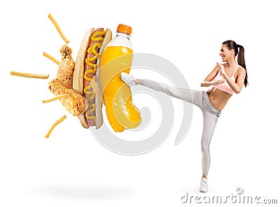 Fit young woman fighting off soda and junk food Stock Photo