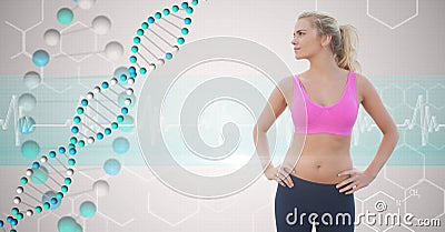 Fit young woman with hands on hips looking at DNA structure Stock Photo