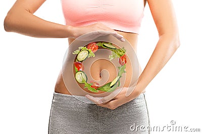 Fit, young woman holding a circle made out of vegetables Stock Photo