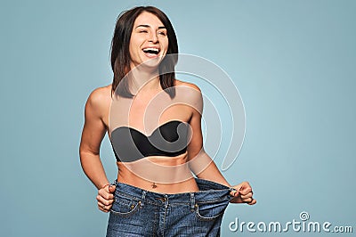 Fit young woman in loose jeans Stock Photo