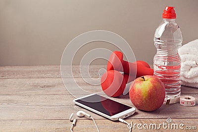 Fitness background with bottle of water, apple and smartphone Stock Photo