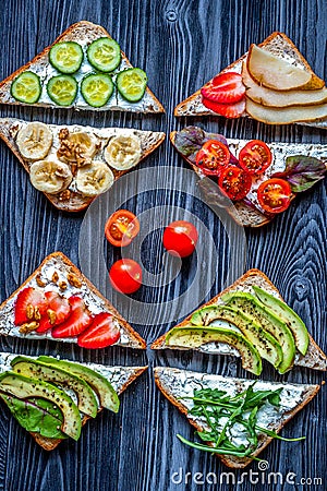 Fitness breskfast with homemade sandwiches dark table background top view Stock Photo