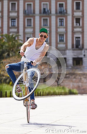 Fitness, city and man riding a bicycle and practicing tricks and skills for a competition. Activity, hobby and casual Stock Photo