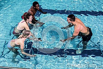 Fitness class doing aqua aerobics on exercise bikes Stock Photo