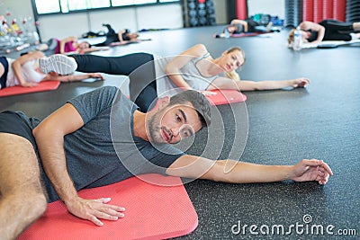 Fitness class in progress man in foreground Stock Photo