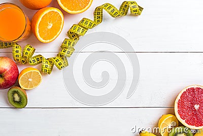 Fitness concept with fruit, a glass of juice and centimeter. Top view background concept. Stock Photo