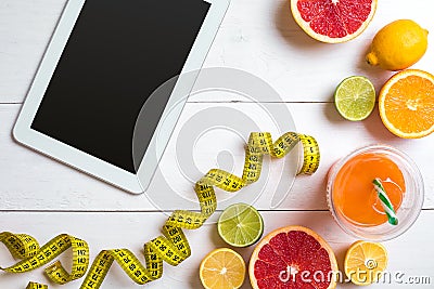 Fitness concept with fruit, a glass of juice and centimeter. Top view background concept. Stock Photo