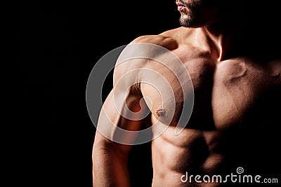 Fitness concept. Muscular and torso of young man having perfect abs, bicep and chest. Male hunk with athletic body. Stock Photo