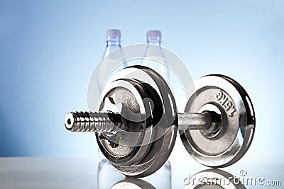 Fitness dumbbell with mineral water Stock Photo
