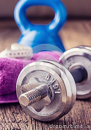Fitness Equipment. Kettlebell dumbbells towel water and measuring tape Stock Photo
