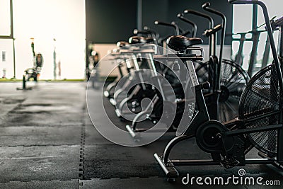 Fitness Equipment. Stationary Bikes Standing In A Row At Empty Gym Stock Photo