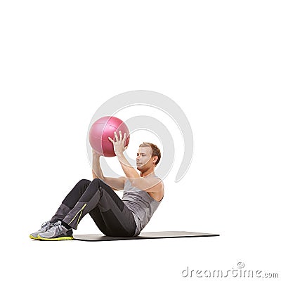 Fitness fanatic. A young man working out with a medicine ball on a white background. Stock Photo