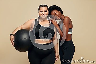 Fitness Friends. Slim And Plus Size Models. Two Different Women In Black Sportswear With Fitness Ball. Stock Photo