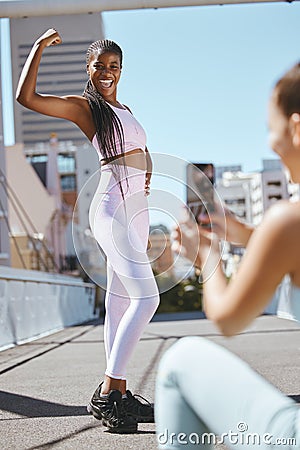 Fitness, friends and social media influencer taking picture of strong power pose for health vlog in a city. Wellness Stock Photo