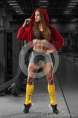 Fitness girl in gym, flat belly, abs. Beautiful muscular woman, shaped abdominal Stock Photo