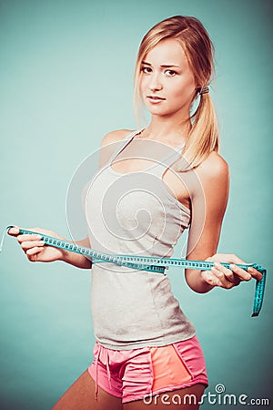 Fitness girl measuring her waistline Stock Photo