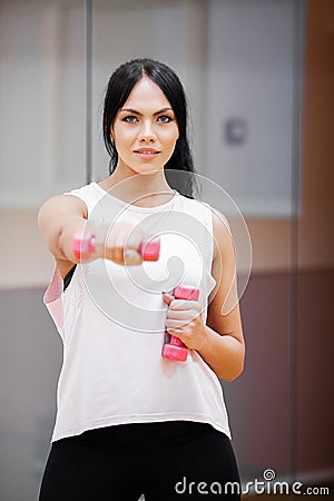 Fitness Girl. Sexy athletic girl working out in gym. Fitness woman doing exercise Stock Photo