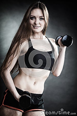 Fitness girl training shoulder muscles lifting dumbbells Stock Photo