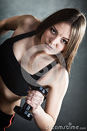 Fitness girl training shoulder muscles lifting dumbbells Stock Photo