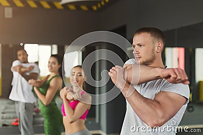 Fitness group warmup stretching training indoors Stock Photo