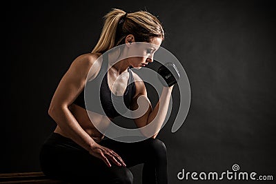 Fitness in gym, sport and healthy lifestyle concept. Beautiful athletic woman showing her trained body on black Stock Photo