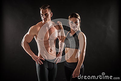 Fitness in gym, sport and healthy lifestyle concept. Couple of athletic man and woman showing their trained bodies on Stock Photo