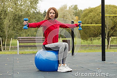 Fitness ,Healthy, Aerobics, Workout, Smiling Young Woman doing exercise with pilates ball on the workout playground Stock Photo
