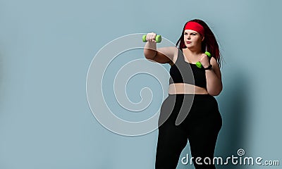 Fitness healthy diet weight loss concept. Lucky plus-size girl overweight woman dieting working out with green weights dumbbells Stock Photo