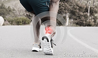 Fitness, injury or runner with ankle pain on road to exercise legs in training or outdoor cardio workout. Red glow Stock Photo
