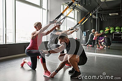 Fitness instructor controlling injury-free performance Stock Photo