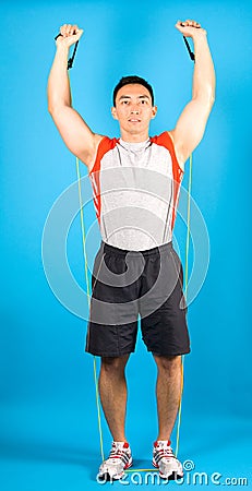 Fitness man use tubing to strengthen Stock Photo