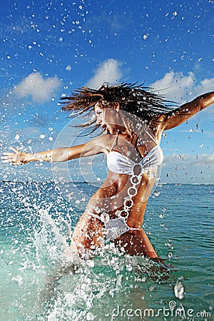 Fitness Model Splashing in Ocean Stock Photo